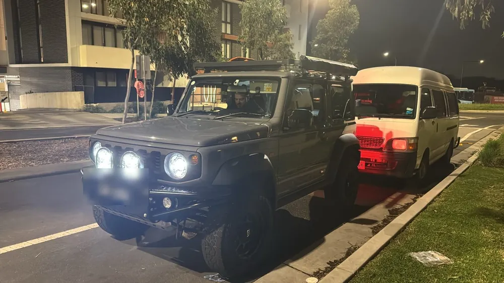 Modified Suzuki Jimny with spotlights at night