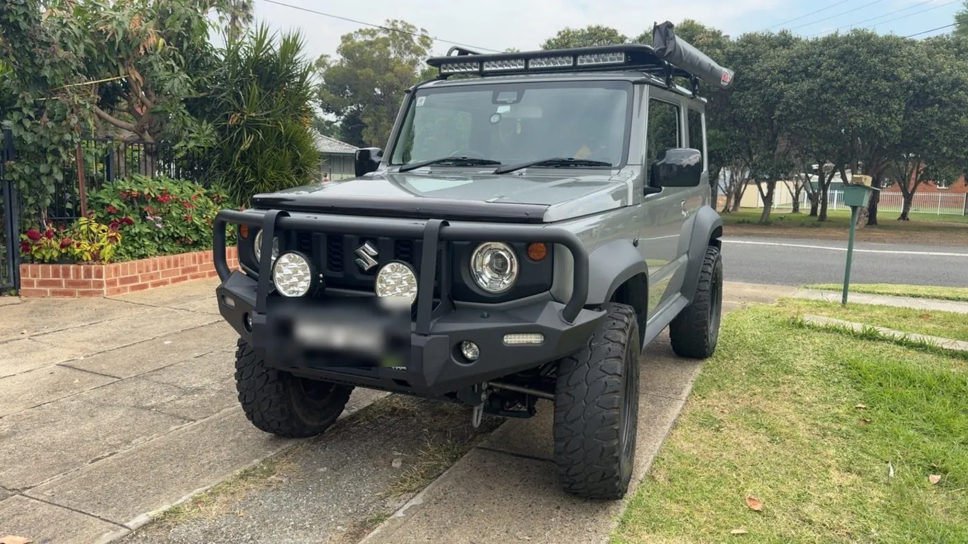 Grey Suzuki Jimny JB74 with bull bar, winch and spotlights